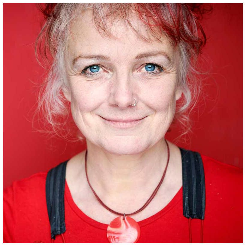 Vik Martin. An approachable looking woman with red and white hair